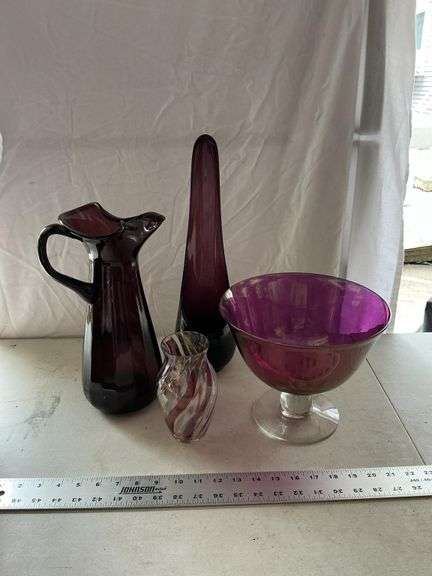 Purple glass pieces-pitcher has a crack by handle