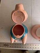 Plastic pig cookie jar and towel holder