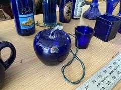 Blue bottles/glassware/oil lamp