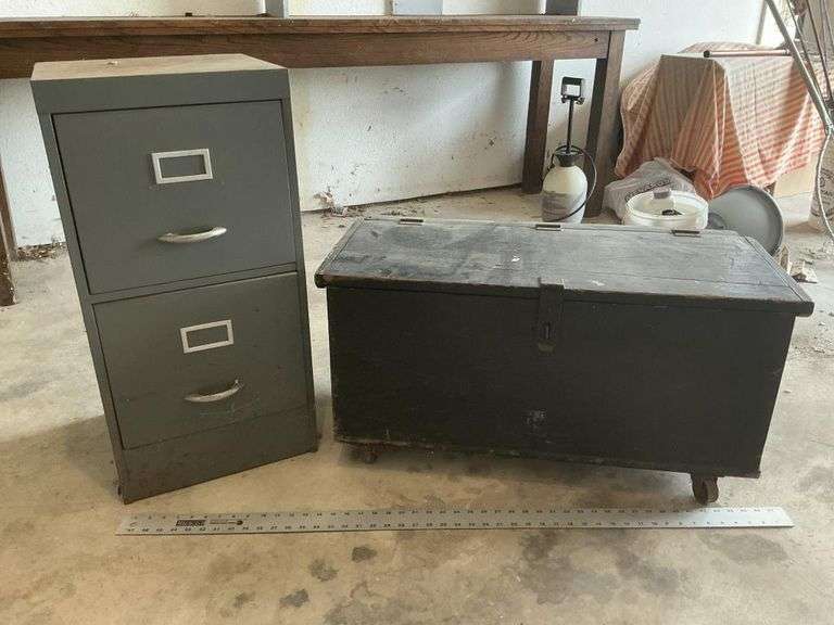 Metal filing cabinet and wooden toolbox on