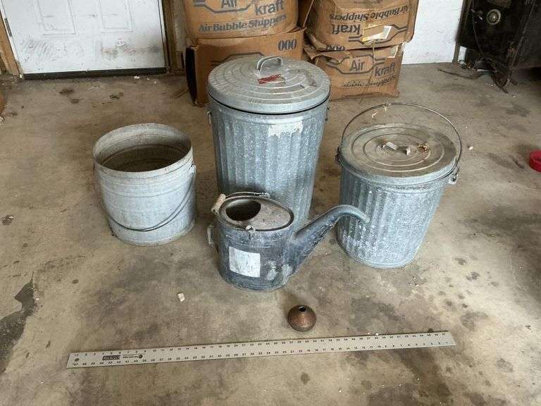 Galvanized watering can and trash cans