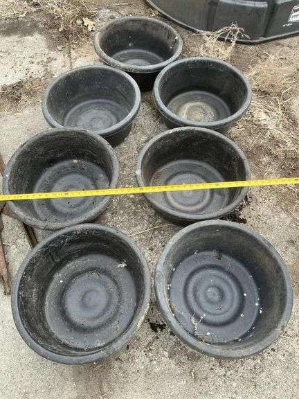 Seven plastic feeder pans