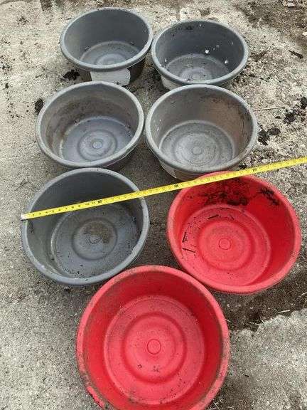 Seven plastic feeder pans