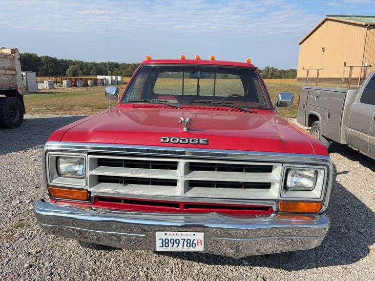 (TITLE) 1988 Dodge 2 Door 4wd Pick Up, 318 V 8 Gas Engine, Title in Hand, 58004 miles, Back Fender Wells Rusted Out, Dents and Dings on Both Sides of Truck, Tailgate Dented and Does Not Open, Passenger Side missing some Trim Pieces, Automatic, AM/FM Radio, AC/Heat, AC not Very Cold, Vinyl Floors, 8 cylinder Gas Engine, New Battery , Newer Tires, Starts and Runs, Driven to Auction Site, Lights Work, Formerly Owned By Dan Balla from Donnellson, He Farmed And Would Drive Around The Community Real Slow Visiting Neighbors. Mileage Is Original.