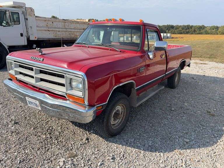 (TITLE) 1988 Dodge 2 Door 4wd Pick Up, 318 V 8 Gas Engine, Title in Hand, 58004 miles, Back Fender Wells Rusted Out, Dents and Dings on Both Sides of Truck, Tailgate Dented and Does Not Open, Passenger Side missing some Trim Pieces, Automatic, AM/FM Radio, AC/Heat, AC not Very Cold, Vinyl Floors, 8 cylinder Gas Engine, New Battery , Newer Tires, Starts and Runs, Driven to Auction Site, Lights Work, Formerly Owned By Dan Balla from Donnellson, He Farmed And Would Drive Around The Community Real Slow Visiting Neighbors. Mileage Is Original.