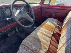 (TITLE) 1988 Dodge 2 Door 4wd Pick Up, 318 V 8 Gas Engine, Title in Hand, 58004 miles, Back Fender Wells Rusted Out, Dents and Dings on Both Sides of Truck, Tailgate Dented and Does Not Open, Passenger Side missing some Trim Pieces, Automatic, AM/FM Radio, AC/Heat, AC not Very Cold, Vinyl Floors, 8 cylinder Gas Engine, New Battery , Newer Tires, Starts and Runs, Driven to Auction Site, Lights Work, Formerly Owned By Dan Balla from Donnellson, He Farmed And Would Drive Around The Community Real Slow Visiting Neighbors. Mileage Is Original.