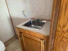 (TITLE) Auction Clerking Trailer, 2000 Model, Star Fire, Clerking Window/ Counter On Both Sides, Air Conditioner Needs Work, Lights Work,Bathroom And Propane Furnace, Storage Cabinets, Clean Low Mile Trailer. Good Tires, No Water Leak Marks On Ceiling, Electric Jack, 2 5/16 “ Ball Hitch