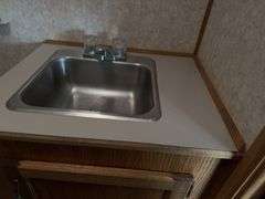 (TITLE) Auction Clerking Trailer, 2000 Model, Star Fire, Clerking Window/ Counter On Both Sides, Air Conditioner Needs Work, Lights Work,Bathroom And Propane Furnace, Storage Cabinets, Clean Low Mile Trailer. Good Tires, No Water Leak Marks On Ceiling, Electric Jack, 2 5/16 “ Ball Hitch