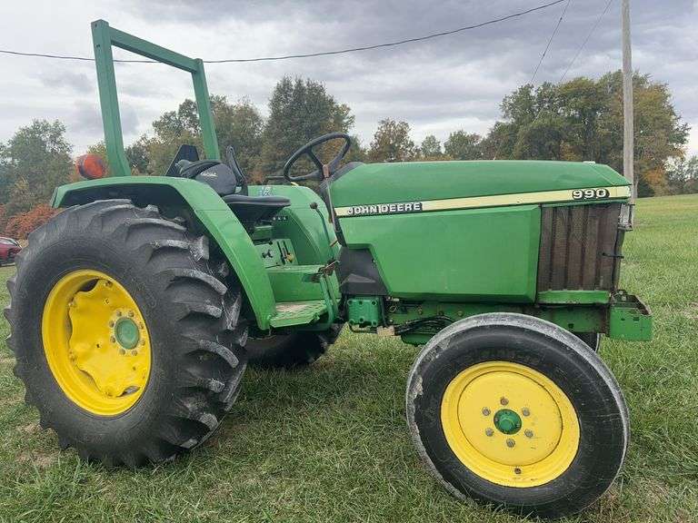 John Deere 990 Compact Tractor, Yanmar 40 HP 4 Cylinder Engine, ROPS,  14.9-24 Rear Tires 50% (Cracked), 6.00-16 Fronts 80%, Rear PTO, Category 1   3 Point Hitch, ROPS, Tachometer Works, Hour Meter Not Working, Fuel And Temp Gauges Working, 9 Forward Speeds, 3 Reverse Speeds, Strong Clutch , Brakes Work, Starts And Runs With No Know Issues, Power Steering 2 Wheel Drive
