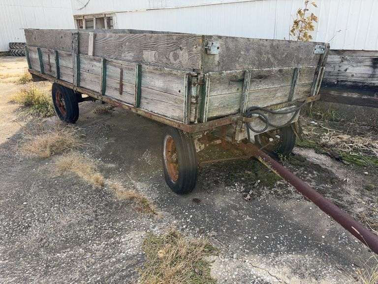 Hay Frame Wagon with SideBoards, 14’ Length x 6’-8” Wide, Spoke Rims, 3 Tires Hold Air, 1 Tire is Flat, Wagon bed has Sheet Metal on Floor, Hydraulic Dump w/ Cylinder,