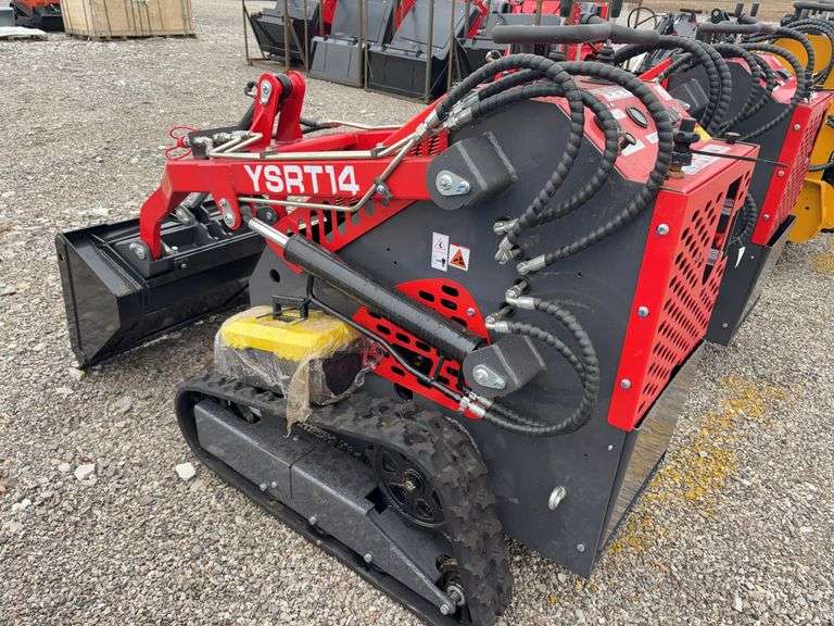 Unused AGT Stand On Skidsteer, Model YSRT14, Gas Engine, 31” Material Bucket, 420 CC (15hp) Engine. Headlights, Hydraulic Hookups on Boom, 6” wide Rubber Tracks,