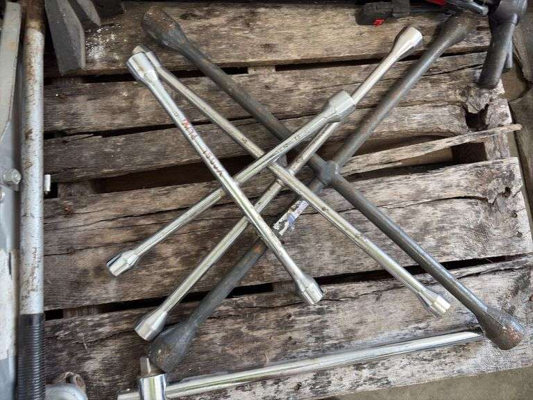 (2) Floor Jacks, 1 missing handle, (3) 4 way lug wrench standard and metric, (2) bicycle air pumps, (2) crow bars, (3) bottle jacks, flood light,