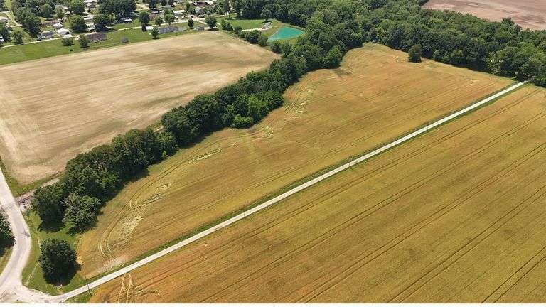 12.234 +/- Acres total; South of E 1625 Avenue and North of RR Tracks;9.62 +/- Acres Tillable with some woods, Rural Water Runs Along  Frontage.