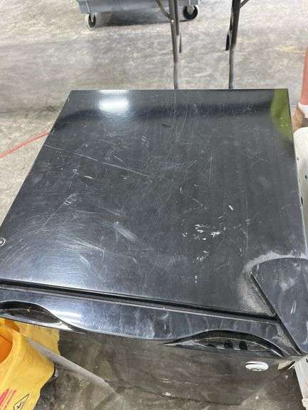 Dorm Size Refrigerator, Black in Color, Does Run, 31.5” Tall x 17.5” Wide x 19” Deep, Small Dents On Top