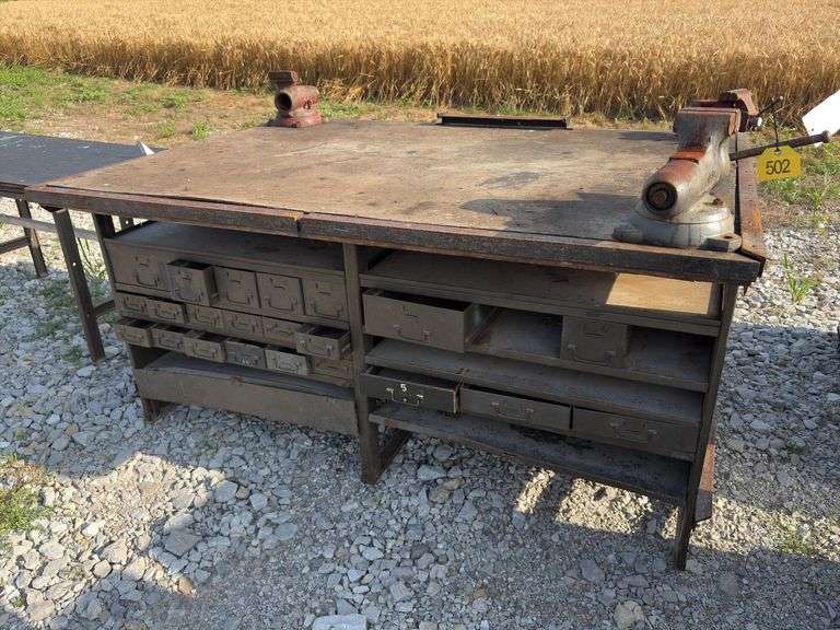 Workbench with 2 vises  size 4” & 3 1/2”, size of workbench is 73” long x 51” wide x 36” high, Masonite ove 2x lumber for workbench top, metal drawers front and back,