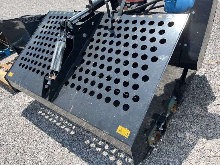 Unused AGT Skid Steer Landscape Rake,
6' wide,
Picks up material as small as 3/4",
Top cover opens hydraulically for ease of dumping,
Skid steer quick attach,
Standard flow hydraulics ,
Model # ECSSLR 72