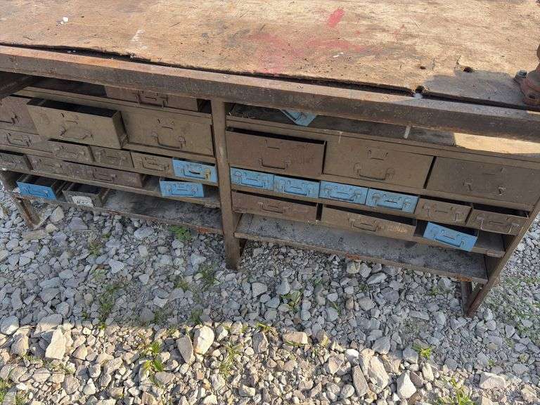 Workbench w/ (2) vises mounted to workbench, Vises are 3 1/2’’, Workbench size is 52” wide x 73” long x 36” high, Metal Frame w/ steel drawers with dividers in them, drawers on both sides of workbench bench, Masonite top over 2x lumber,