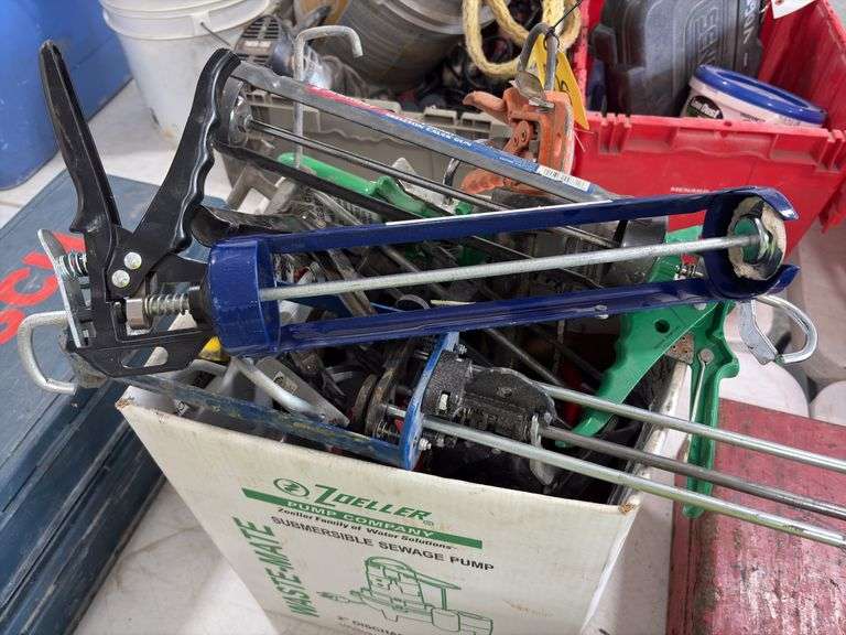 Bucket of Caulk Guns, quart, regular, and 2 part epoxy guns,
