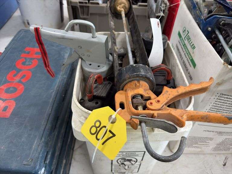 Bucket of caulk Guns, regular, quart and 2 part epoxy guns,