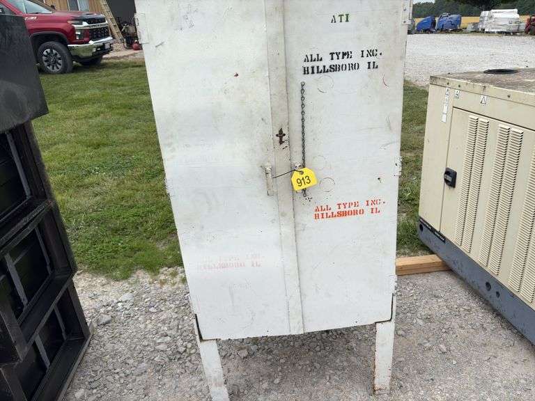 Metal Storage Cabinet 31” wide x 24” deep x 64” high, with 2 doors on cabinet, inside of cabinet has grease, transmission fluid, battery cleaner,  multi purpose lubricate, carburetor cleaner, house and siding cleaner, bag of rags, oil filters,