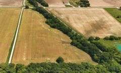 12.234 +/- Acres total; South of E 1625 Avenue and North of RR Tracks;9.62 +/- Acres Tillable with some woods, Rural Water Runs Along  Frontage.