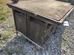 Workbench w/ (2) vises mounted to workbench, Vises are 3 1/2’’, Workbench size is 52” wide x 73” long x 36” high, Metal Frame w/ steel drawers with dividers in them, drawers on both sides of workbench bench, Masonite top over 2x lumber,