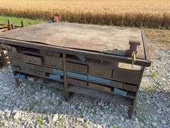 Workbench w/ (2) vises mounted to workbench, Vises are 3 1/2’’, Workbench size is 52” wide x 73” long x 36” high, Metal Frame w/ steel drawers with dividers in them, drawers on both sides of workbench bench, Masonite top over 2x lumber,