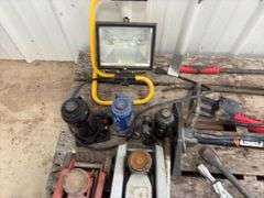 (2) Floor Jacks, 1 missing handle, (3) 4 way lug wrench standard and metric, (2) bicycle air pumps, (2) crow bars, (3) bottle jacks, flood light,