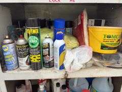 Metal Storage Cabinet 31” wide x 24” deep x 64” high, with 2 doors on cabinet, inside of cabinet has grease, transmission fluid, battery cleaner,  multi purpose lubricate, carburetor cleaner, house and siding cleaner, bag of rags, oil filters,