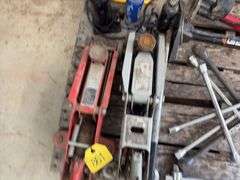 (2) Floor Jacks, 1 missing handle, (3) 4 way lug wrench standard and metric, (2) bicycle air pumps, (2) crow bars, (3) bottle jacks, flood light,