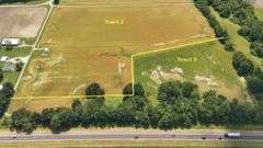 North of E 1625 Avenue/West of N 1125 Street including two older bins) 20.50 +/- Acres Tillable with wooded acres.  23.24 +/- Acres total, Rural Water Runs Along Frontage