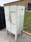 Metal Storage Cabinet 31” wide x 24” deep x 64” high, with 2 doors on cabinet, inside of cabinet has grease, transmission fluid, battery cleaner,  multi purpose lubricate, carburetor cleaner, house and siding cleaner, bag of rags, oil filters,