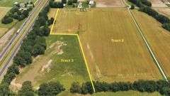 North of E 1625 Avenue/West of N 1125 Street including two older bins) 20.50 +/- Acres Tillable with wooded acres.  23.24 +/- Acres total, Rural Water Runs Along Frontage