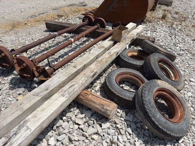 Mobile Home Axles,(2) with brakes (1) with out brakes, (5) wheels with lug nuts, (2) wood beams 4”x6”x 11’- 9”, good tread left on tires, hold air,
