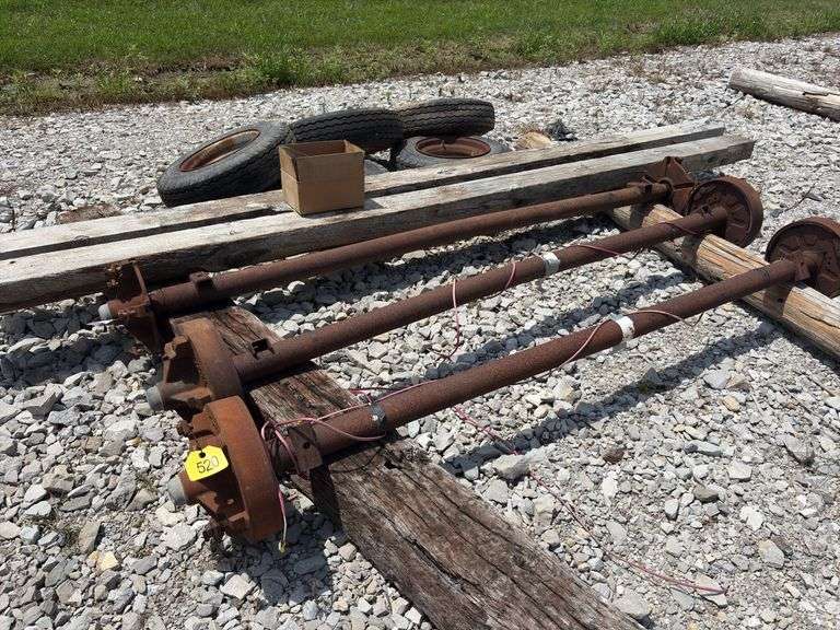 Mobile Home Axles,(2) with brakes (1) with out brakes, (5) wheels with lug nuts, (2) wood beams 4”x6”x 11’- 9”, good tread left on tires, hold air,