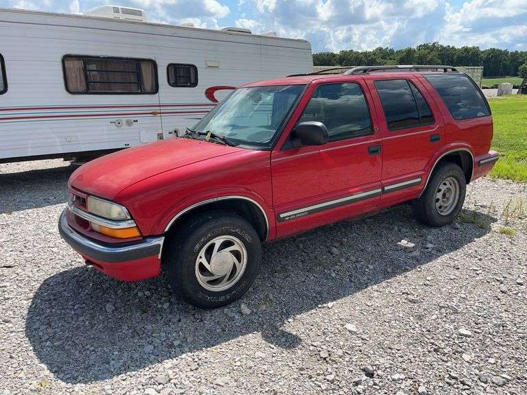 (TITLE) 1999 Chevrolet Blazer,  Touch 4 Wheel Drive, Starts And Runs, AM/FM CD Player, AUX Jack, Cruise Control, Power Steering, Push Button Rear Hatch, Rear Defrost, Leather Front Bucket Seats In Rough Condition, Center Counsel Is Broken, Hood Release Latch In Cab IS Broke, Back Hatch Opens, P235/75R15 Tires Approx 50% Tread, Body in Fair Condition Just Scratches and Losing Clearcoat and Some Minor Dents, 180,202 Miles, Does Have Dead Battery, Signed Title In Hand