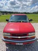 (TITLE) 1999 Chevrolet Blazer,  Touch 4 Wheel Drive, Starts And Runs, AM/FM CD Player, AUX Jack, Cruise Control, Power Steering, Push Button Rear Hatch, Rear Defrost, Leather Front Bucket Seats In Rough Condition, Center Counsel Is Broken, Hood Release Latch In Cab IS Broke, Back Hatch Opens, P235/75R15 Tires Approx 50% Tread, Body in Fair Condition Just Scratches and Losing Clearcoat and Some Minor Dents, 180,202 Miles, Does Have Dead Battery, Signed Title In Hand