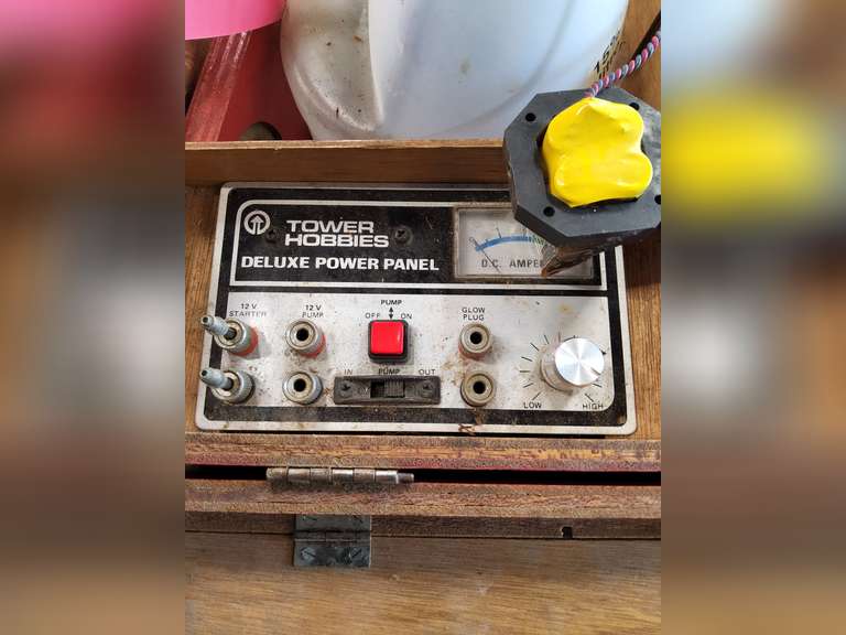 Radio controlled accessories, deluxe pwr panel, elec fuel pump, plane propellers, half gallon of fuel & other misc in wood case