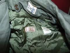 Group: Military winter coat & pants, frame/harness for a AN/PRC-77 portable radio, & other SEE PICS