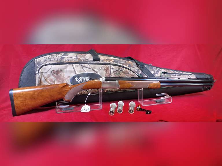 Ruger Mod: Red Label, 12ga over under shotgun, Ser#: 411-68136 , 26" VR brl, 3", 5 screw in chokes & wrench, wood furniture, blued brls, stainless receiver, soft case, 98%
