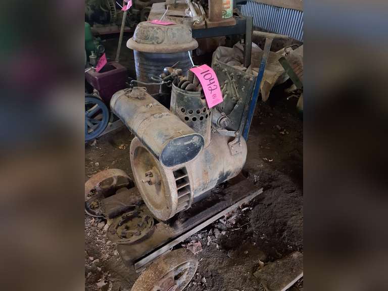 Gas powered engine (may not be complete) mounted on 3 wheel trolley cart