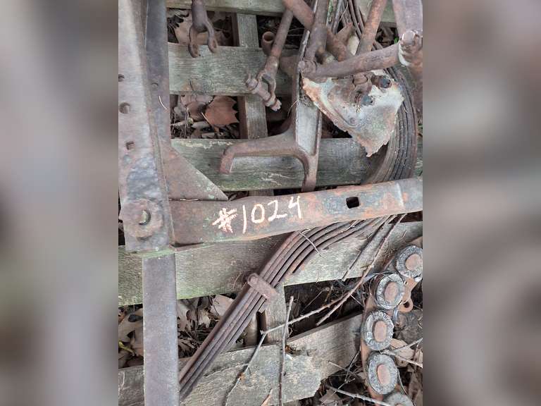Model T Frame, rear axle, pair leaf springs, frt axle, engine block, pair of rims, crank & other parts