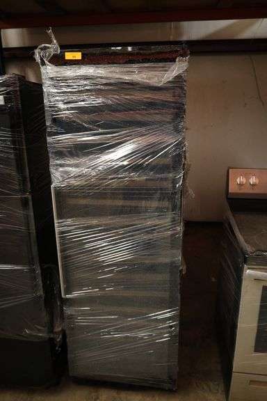 Glass Front Refrigerator with broken glass on door.