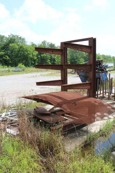 METAL RACK OUTSIDE OF SHOP WITH CONTENTS