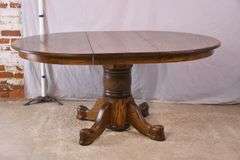 Round oak single pedestal dining table with 1 skirted leaf; 3453-045