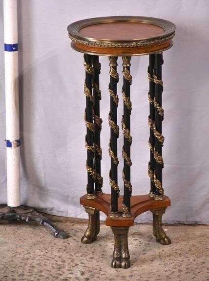 Small round bronze mounted side table with hoof feet and black columns ...