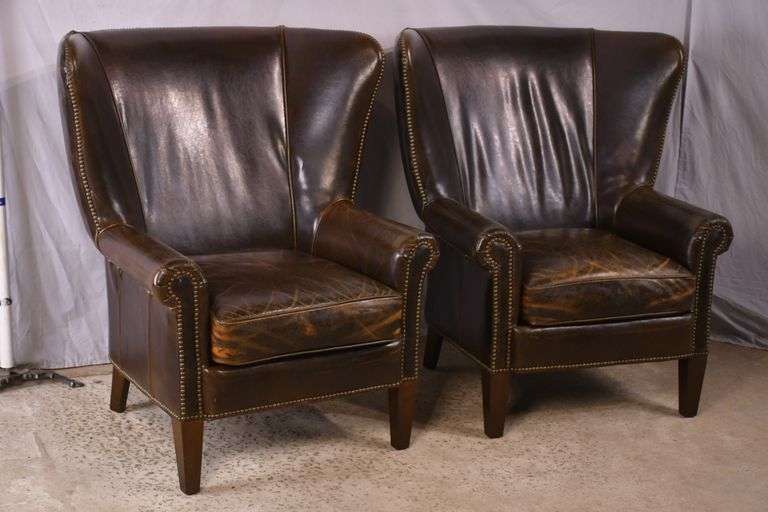 Pair of Paul Robert distressed brown leather wingback armchairs; 336-3831
