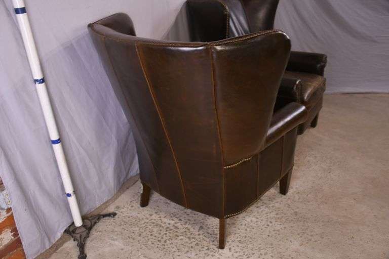 Pair of Paul Robert distressed brown leather wingback armchairs; 336-3831