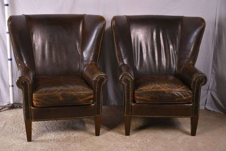 Pair of Paul Robert distressed brown leather wingback armchairs; 336-3831