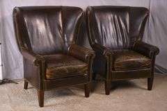 Pair of Paul Robert distressed brown leather wingback armchairs; 336-3831